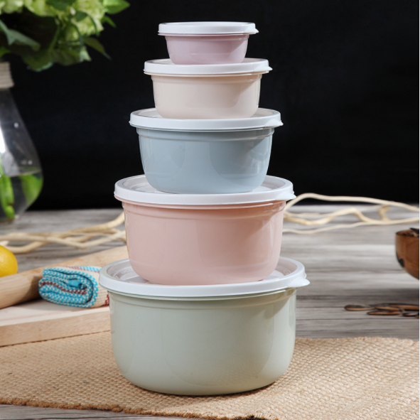 Five round food storage containers with white lids stacked from largest to smallest in pastel colors